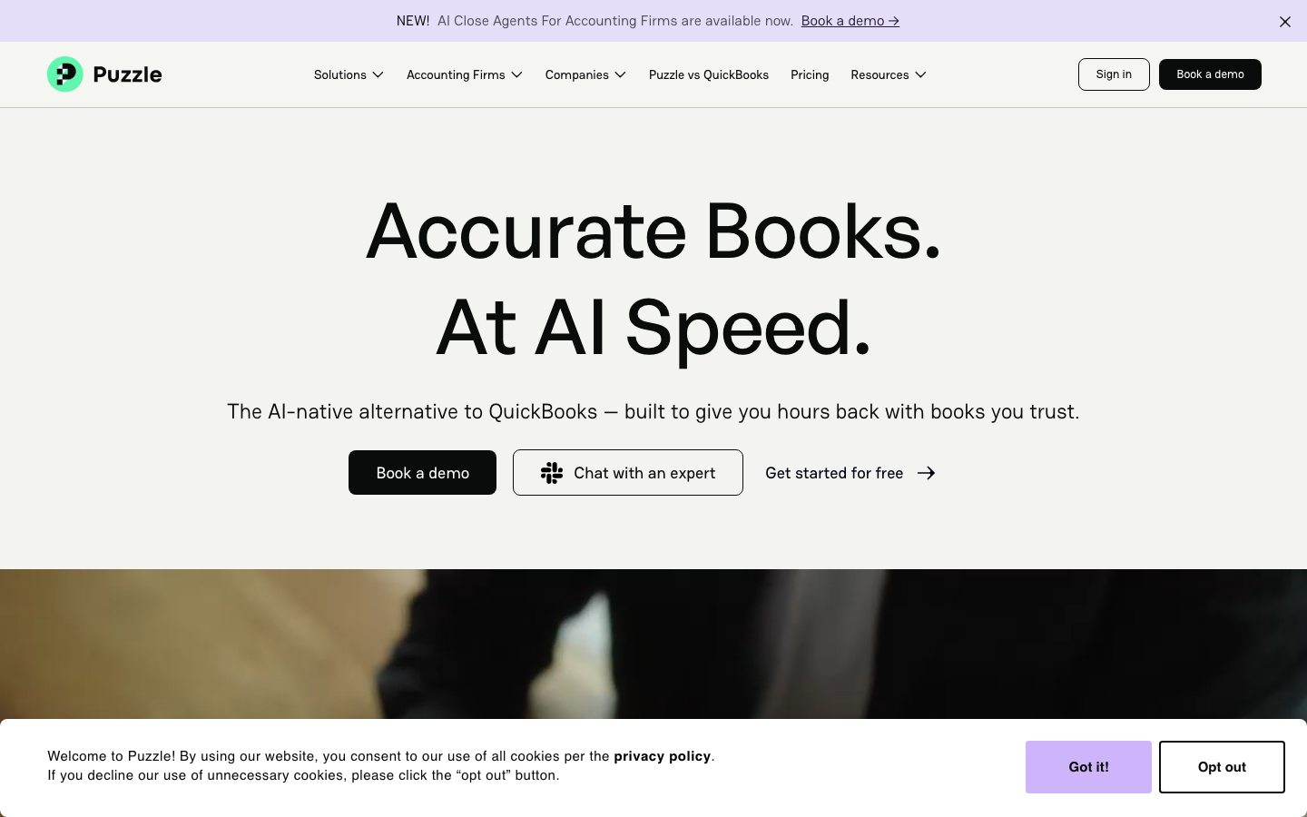 Puzzle accounting homepage showing accurate books at AI speed headline with book a demo CTA
