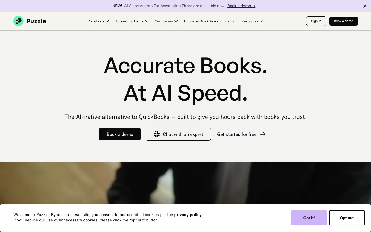 Puzzle accounting homepage showing accurate books at AI speed headline with book a demo CTA