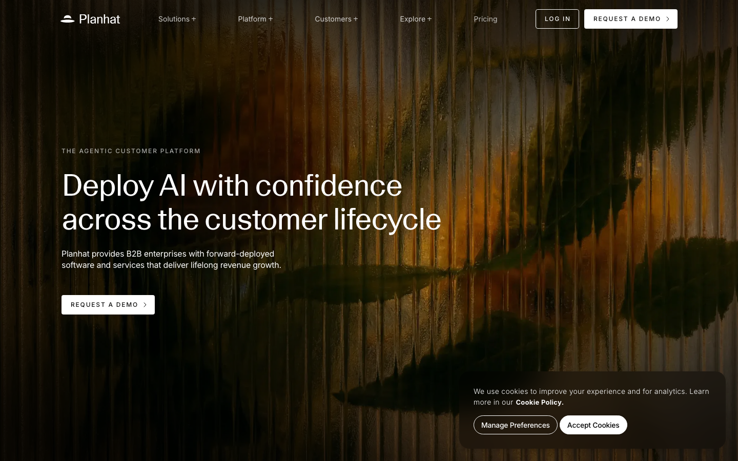 Planhat homepage with agentic customer platform headline and AI deployment across the lifecycle