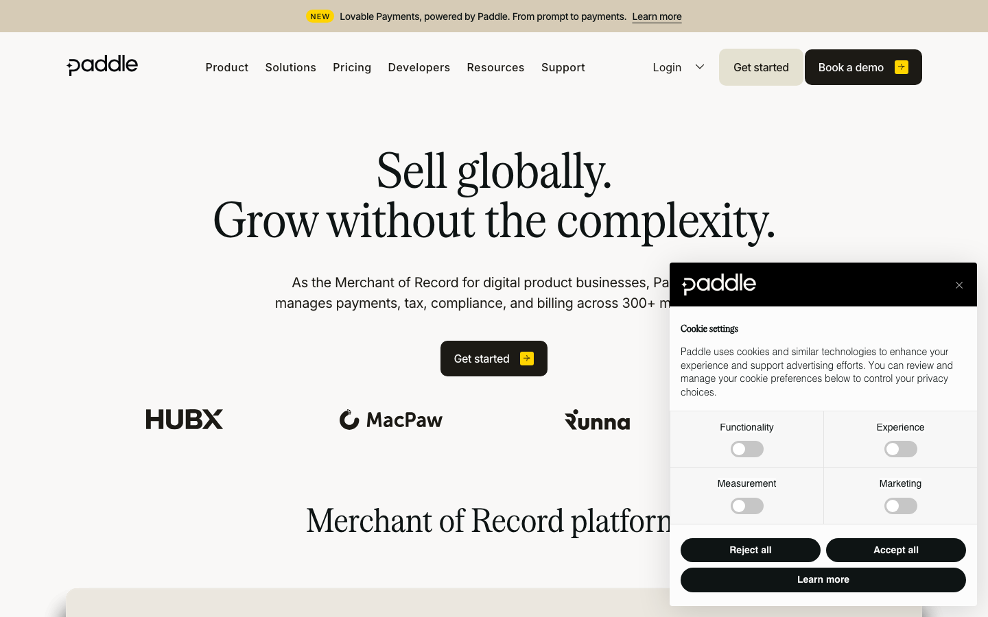 Paddle homepage showing merchant of record positioning with global payments and tax compliance