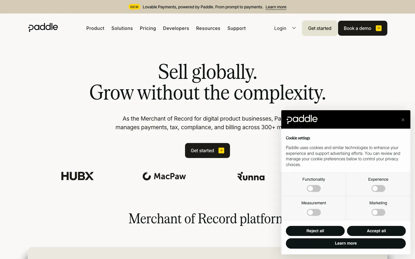 Paddle homepage showing merchant of record positioning with global payments and tax compliance